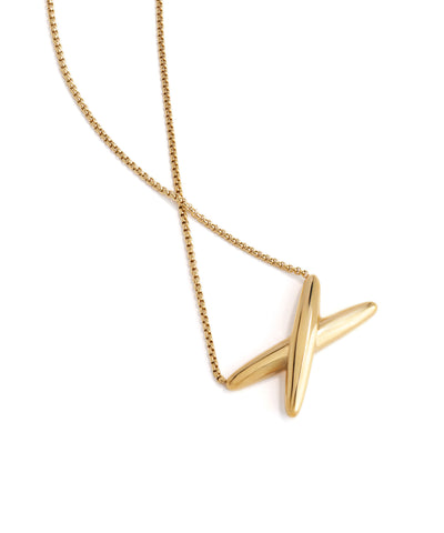 Gold necklace with a geometric pendant on a white background