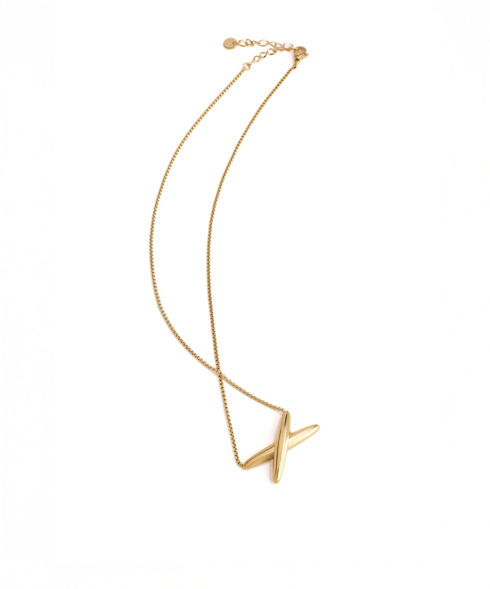 Gold necklace with a unique pendant on a white background