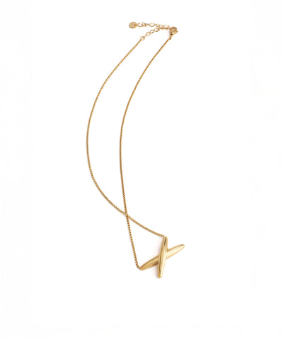 Gold necklace with a unique pendant on a white background