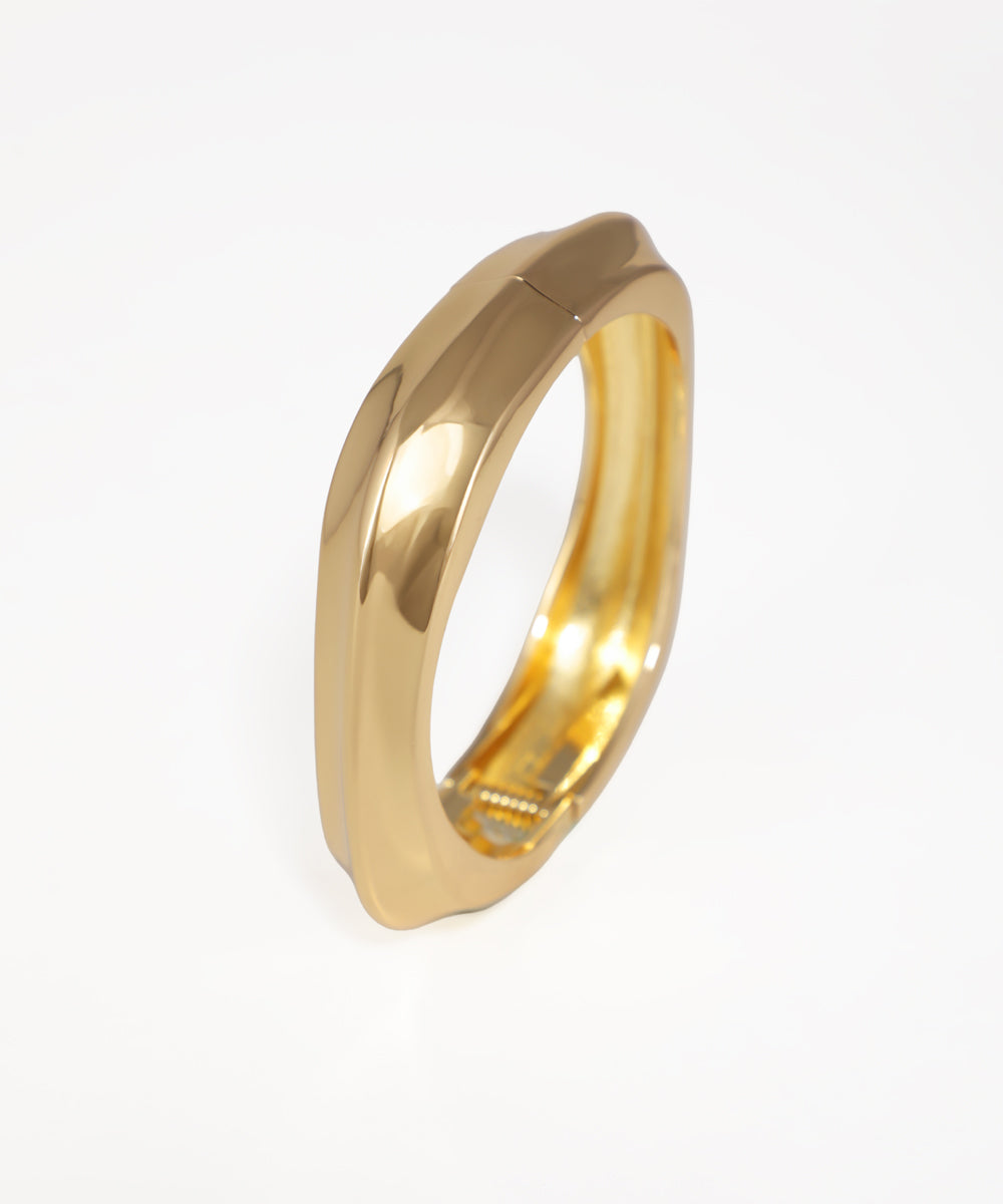 Gold ring on a light gray background