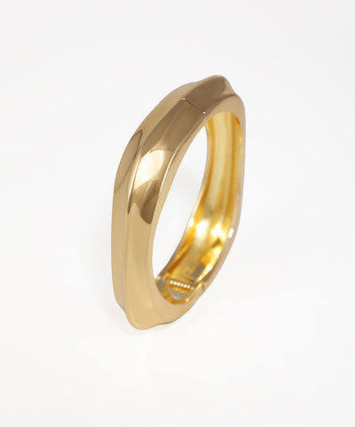 Gold ring on a light gray background
