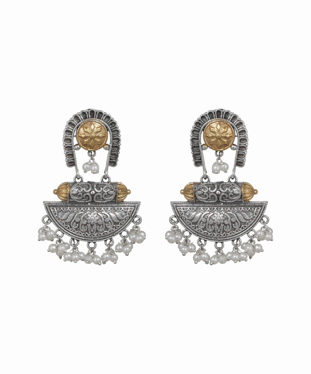 Pair of ornate earrings with intricate designs on a white background