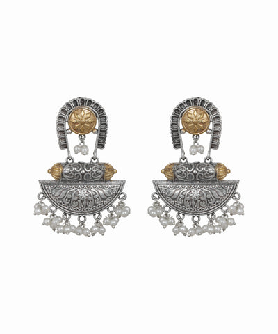 Pair of ornate earrings with intricate designs on a white background