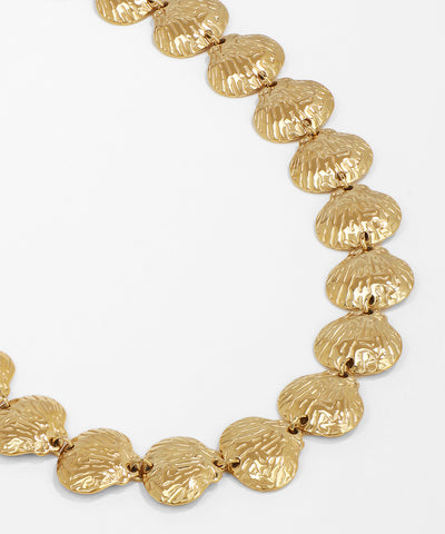 Gold necklace with shell-like links on a white background