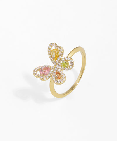 Gold-tone ring with a butterfly design, featuring clear and colorful cubic zirconia stones in pink, orange, yellow, and green.