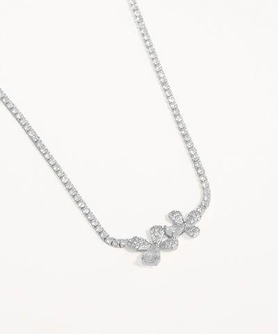 Silver necklace with a delicate pendant on a white background