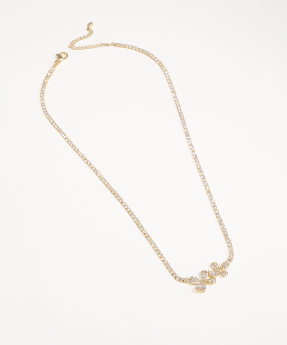Gold-tone necklace with a delicate chain and shimmering CZ floral cluster motif