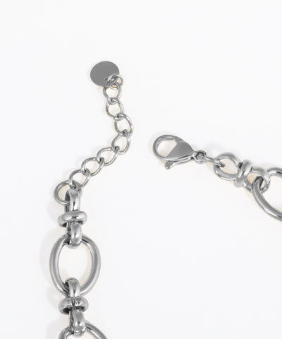 Close-up of a silver bracelet on a white background