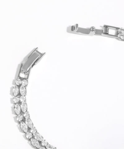 Silver bracelet with clear gemstones on a white background