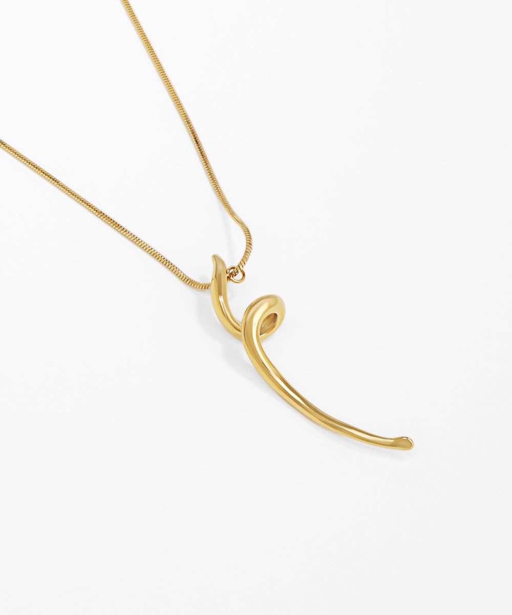 Gold necklace with a unique pendant on a white background