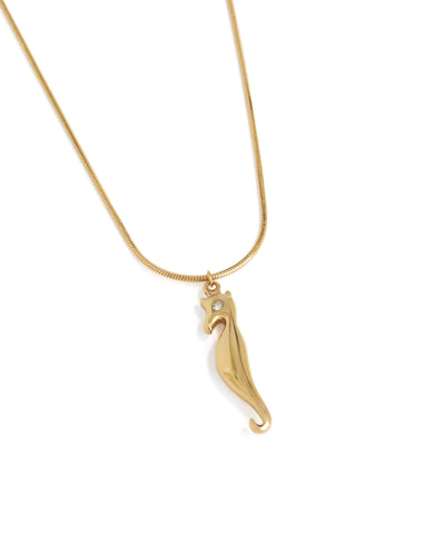Gold necklace with a seahorse pendant on a white background