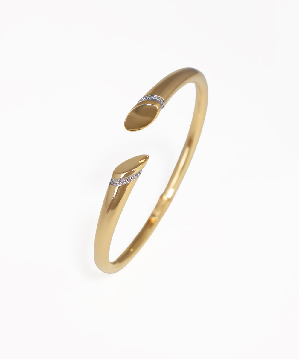 Gold bracelet with small diamonds on a white background