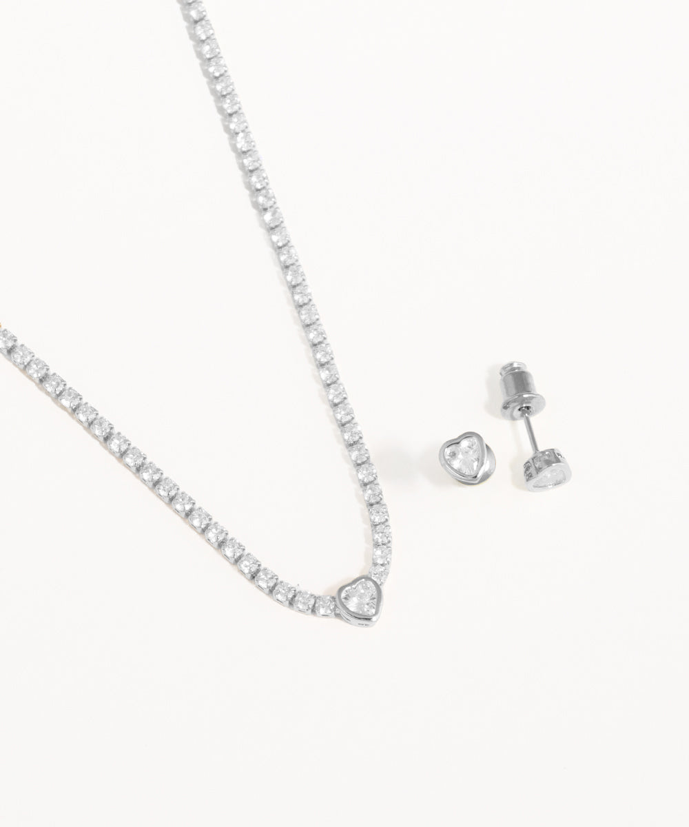 Silver necklace and earrings on a white background