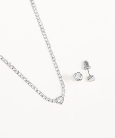 Silver necklace and earrings on a white background