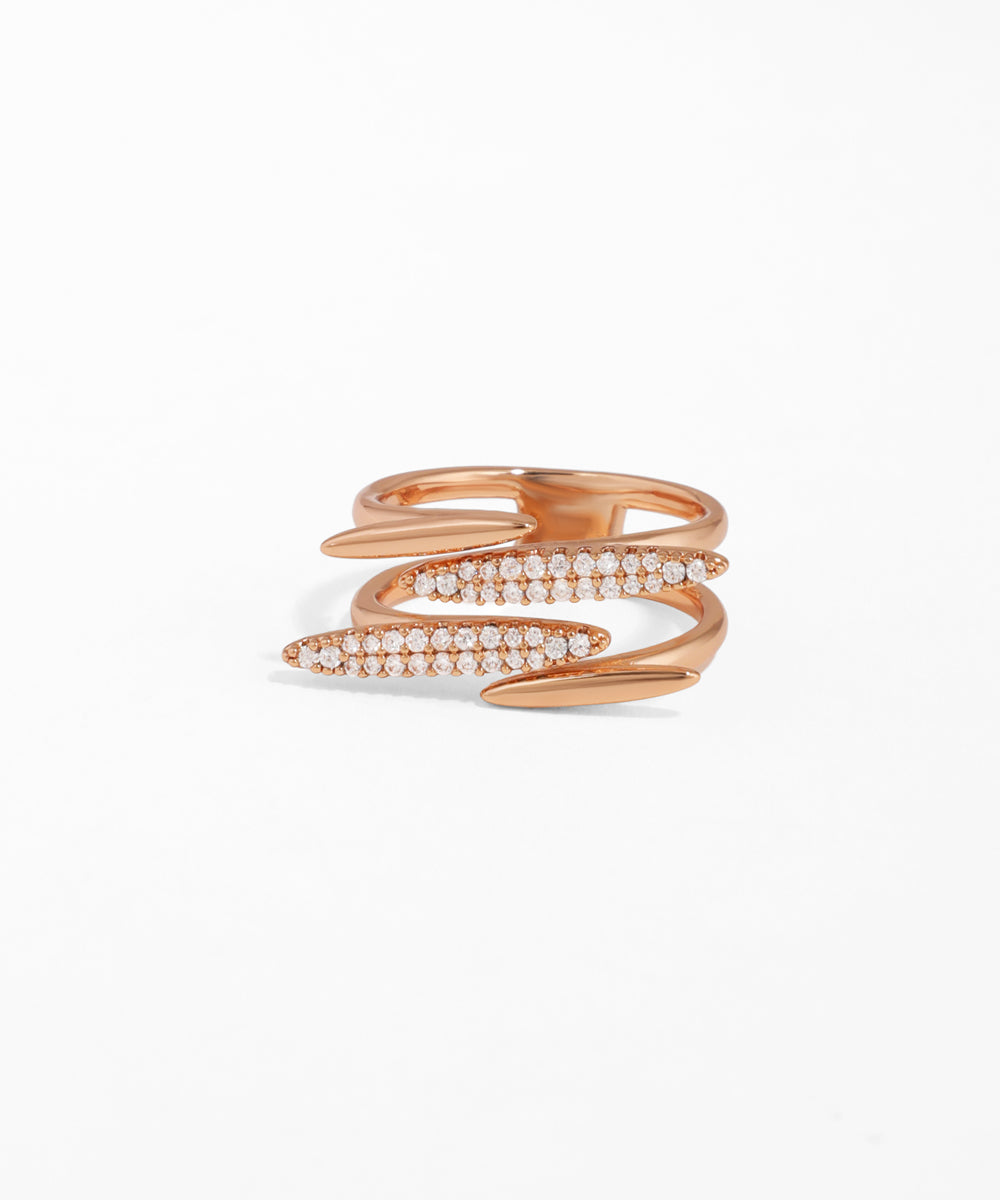 Rose gold snake-shaped ring with embedded stones on a white background