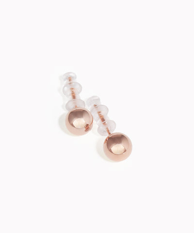 Pair of rose gold and clear bead earrings on a white background