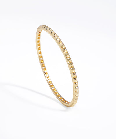 Gold-tone bracelet with all-over geometric pyramid studs and a shiny finish.