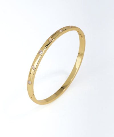 Gold bracelet with small diamonds on a white background
