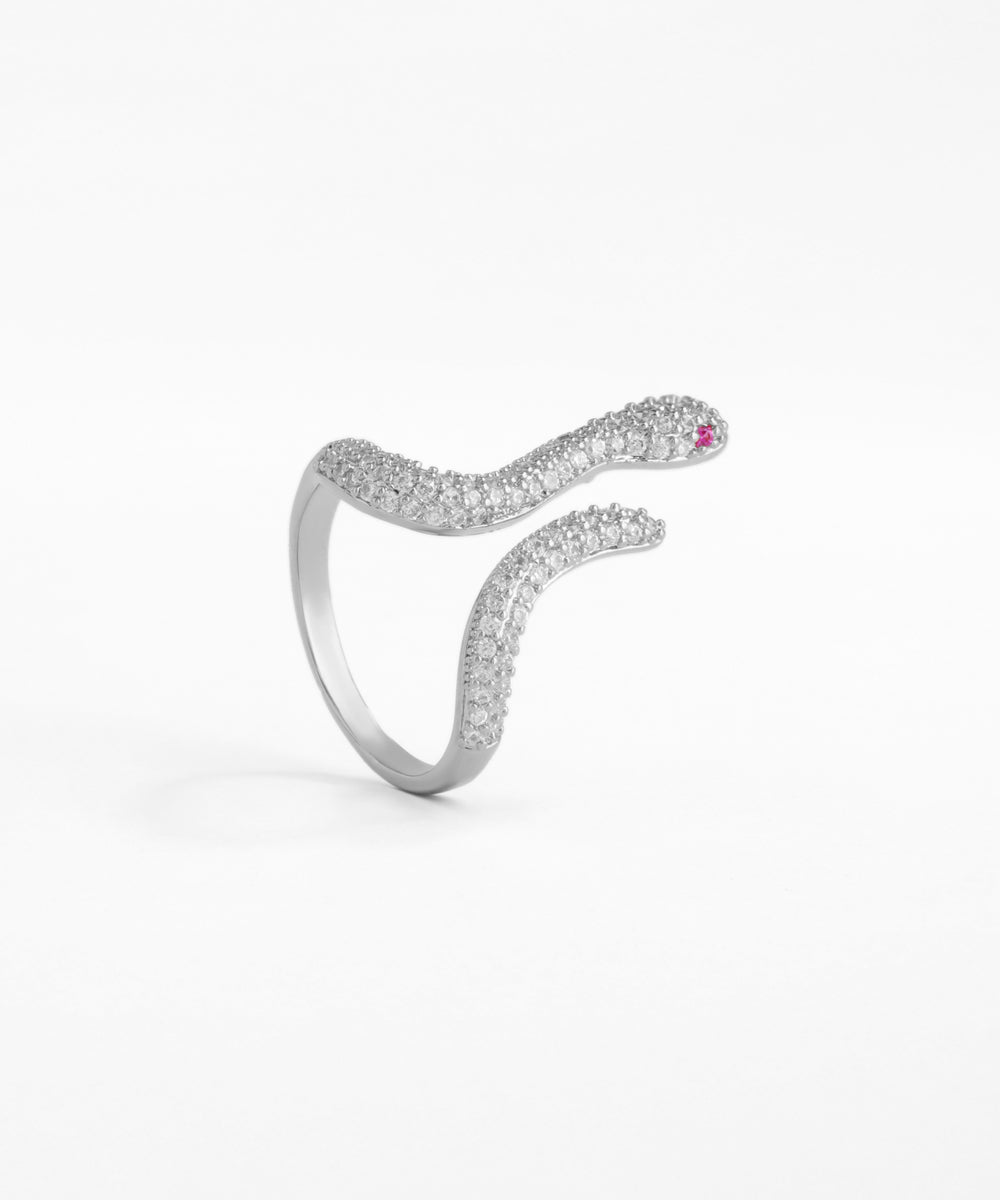 Silver snake-shaped ring with gemstones on a white background
