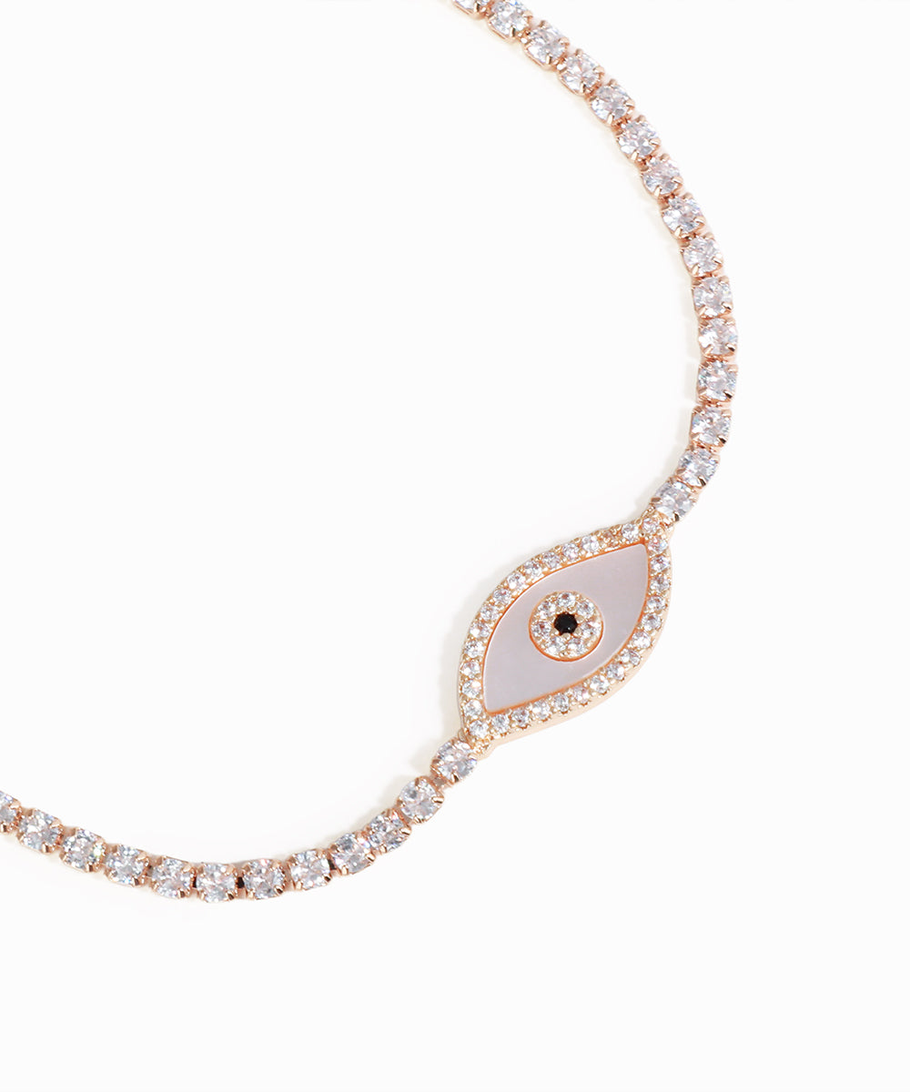 Rose gold bracelet with an eye-shaped charm on a white background