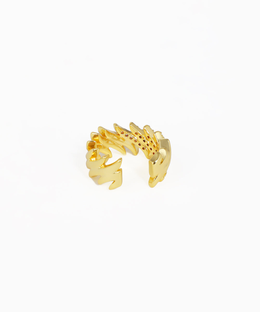 Gold ring with a unique design on a white background