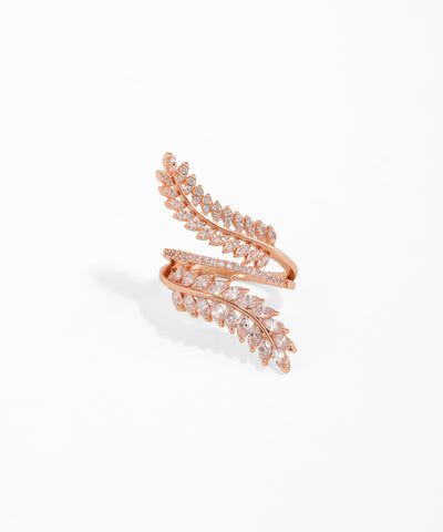 Rose gold leaf-shaped earring with clear stones on a white background