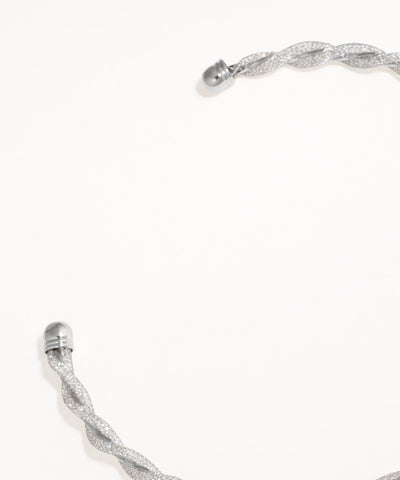 Silver bracelet with a braided design on a white background