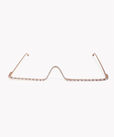Rose gold eyeglass frame on a white background