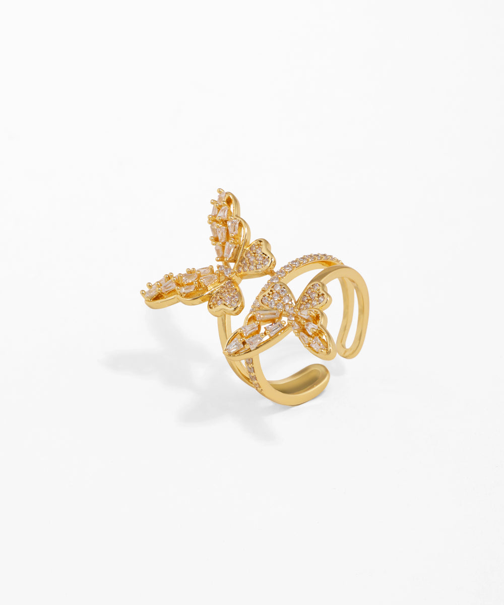 Gold-tone ring with two sparkling CZ-studded butterfly motifs, adjustable open band.