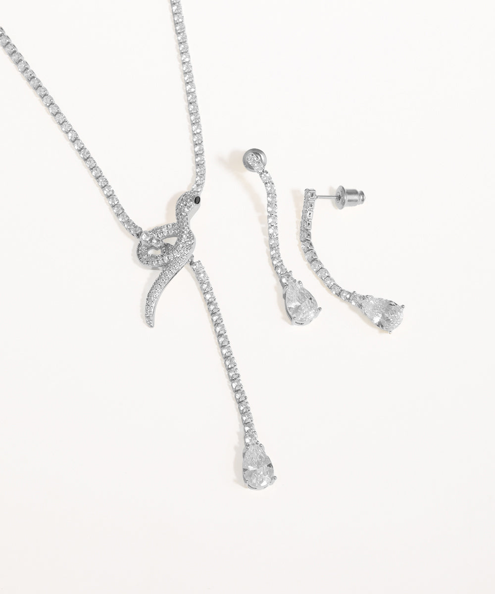 Silver jewelry set with necklace and earrings on a white background
