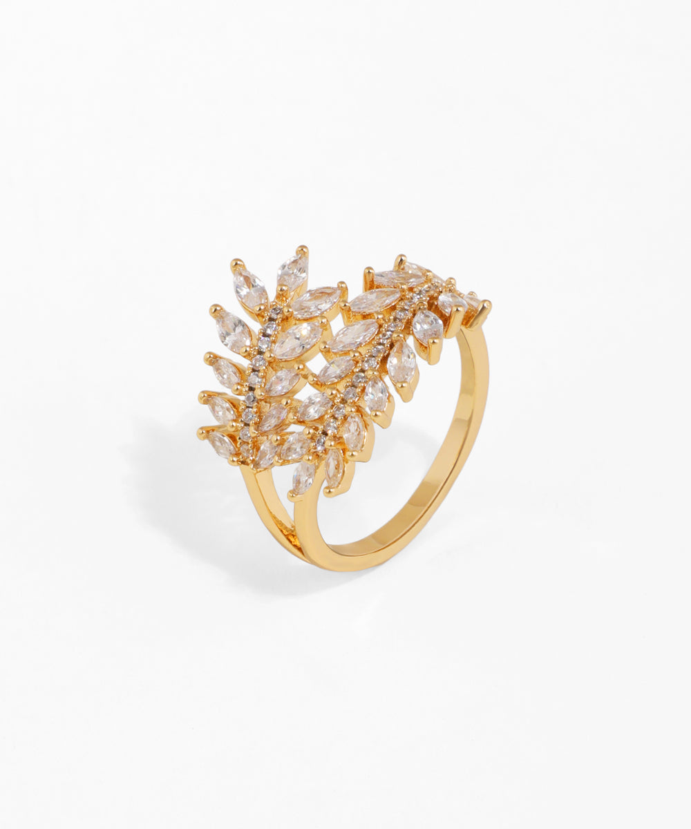 Gold ring with diamond-like stones on a white background