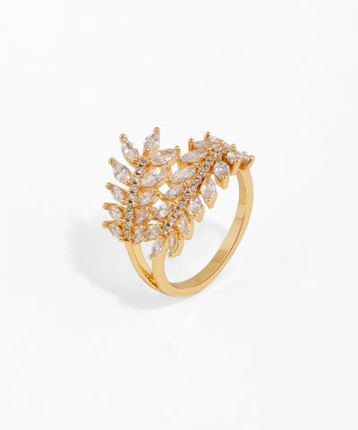 Gold ring with diamond-like stones on a white background
