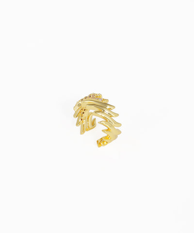 Gold ring with a leaf-like design on a white background