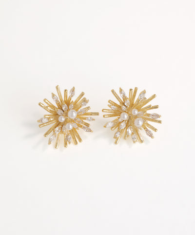 Gold and pearl earrings on a white background