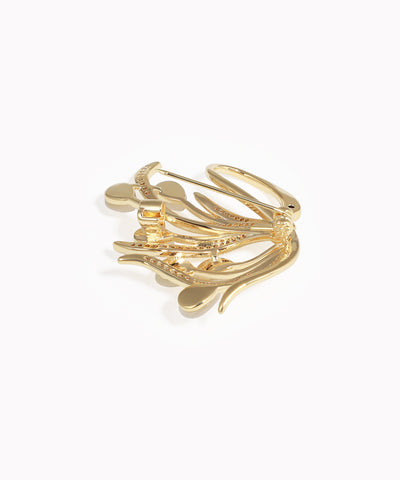 Gold ring with leaf-like designs on a white background