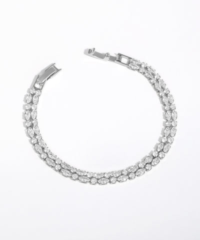 Silver bracelet with clear stones on a white background