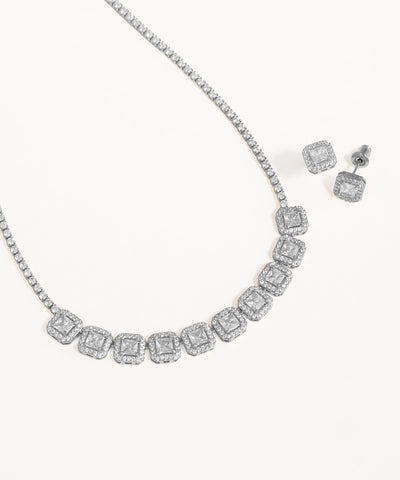 Diamond necklace and earrings on a white background