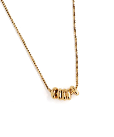 Gold necklace with a unique clasp design on a white background