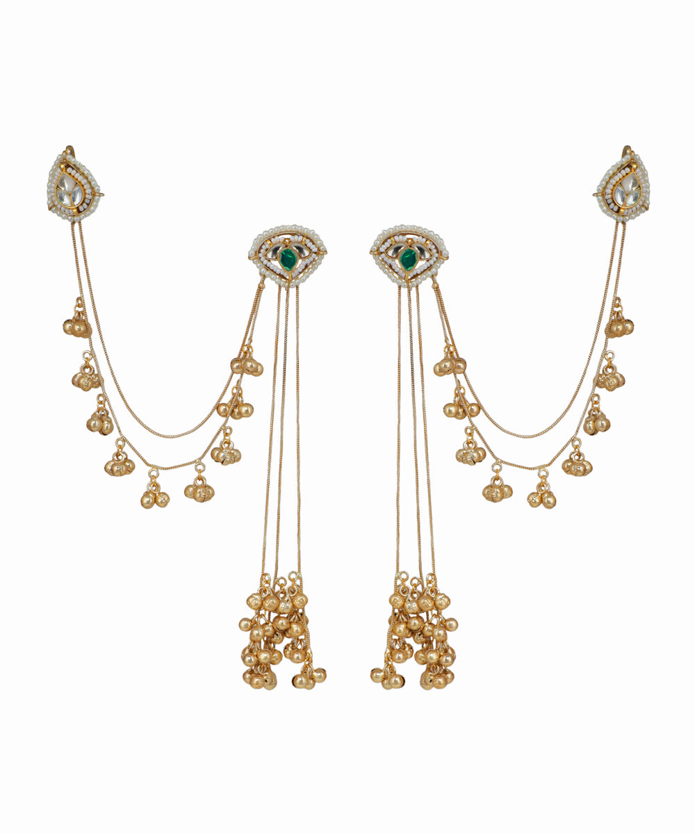 Pair of gold earrings with green gemstones on a white background