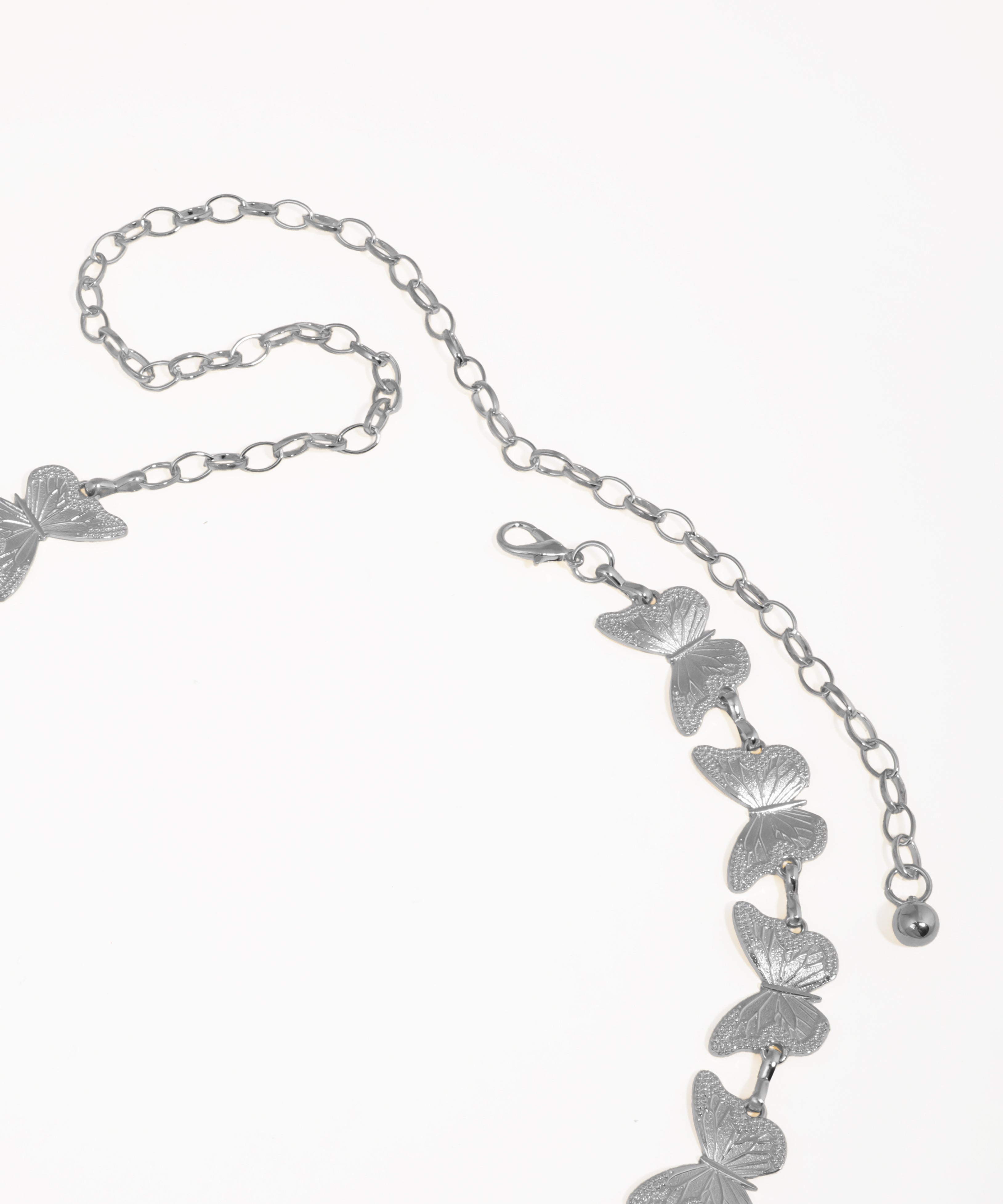 Gold butterfly necklace on a white background