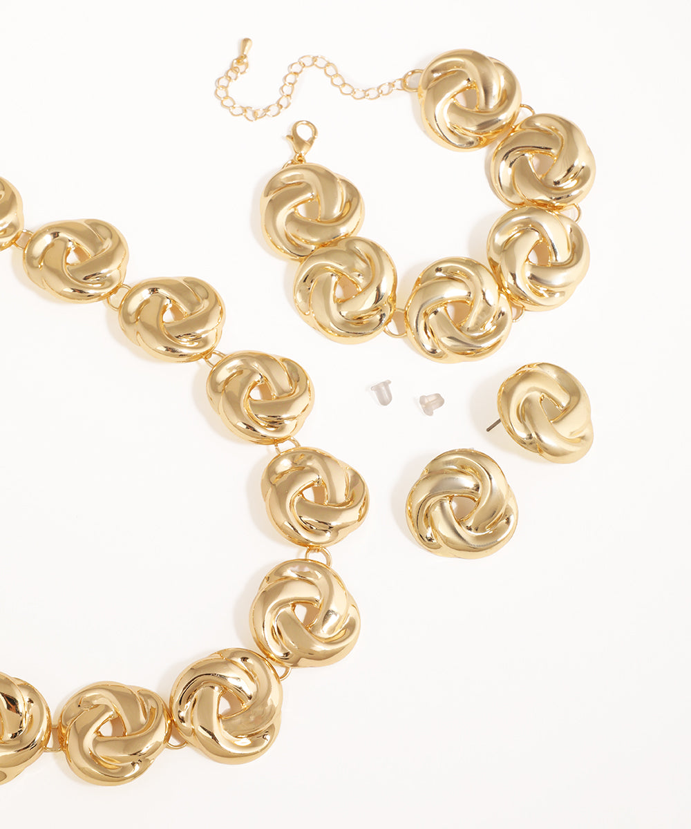 Gold jewelry set with necklace and earrings on a white background