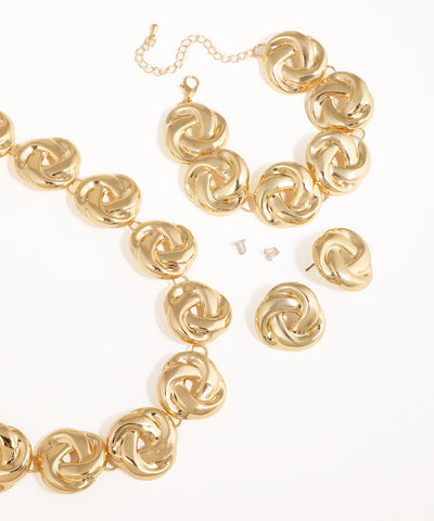 Gold jewelry set with necklace and earrings on a white background