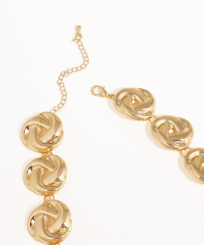 Gold bracelet with interlocking on a white background