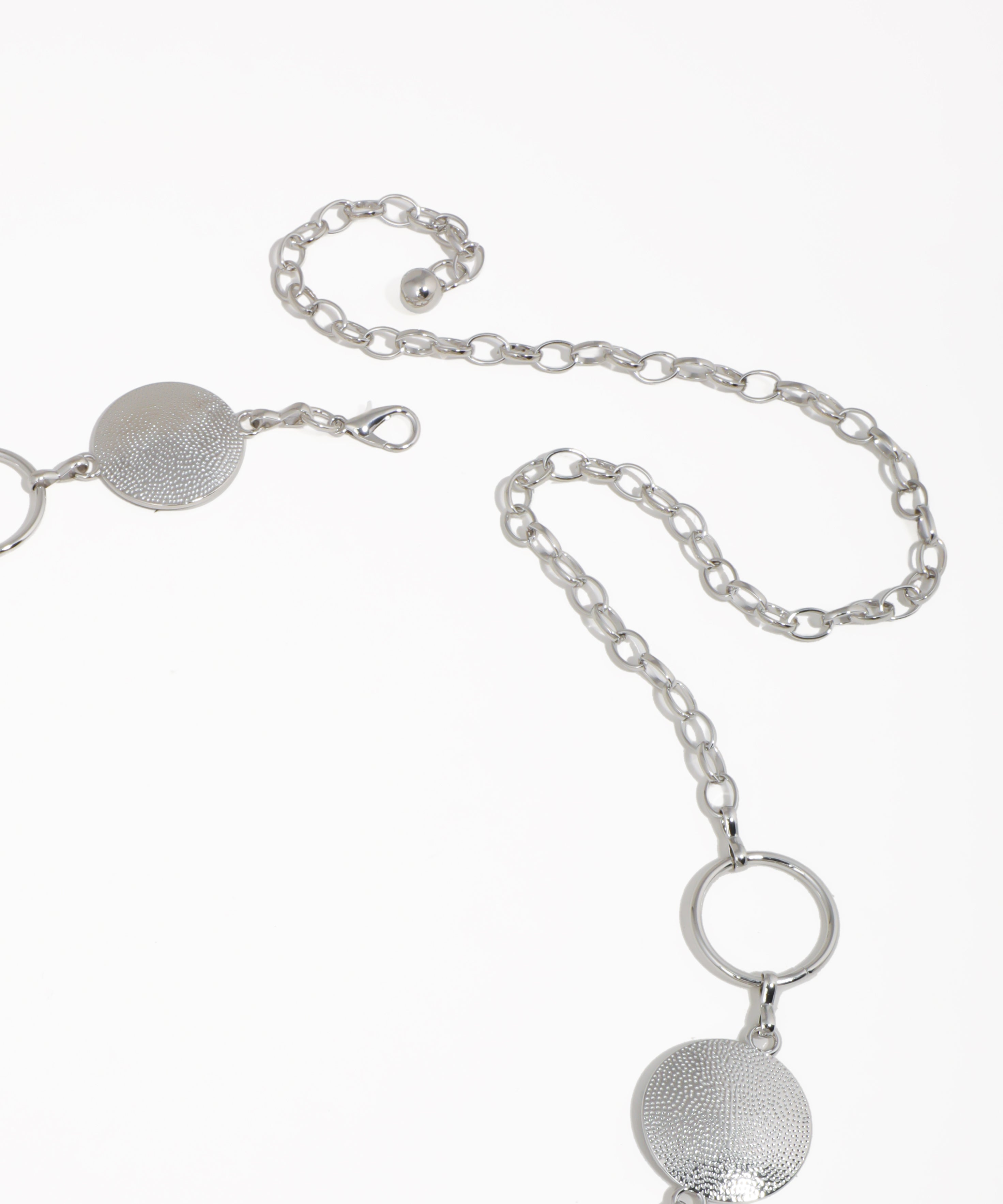 Silver necklace with circular pendants on a white background