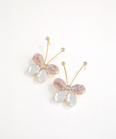 Butterfly-shaped earrings with pink and white stones on a white background