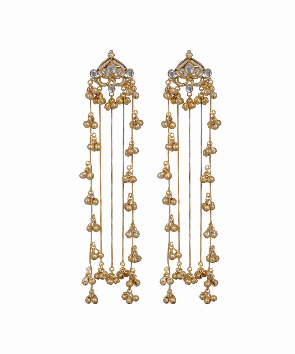 Gold earrings with dangling beads on a white background