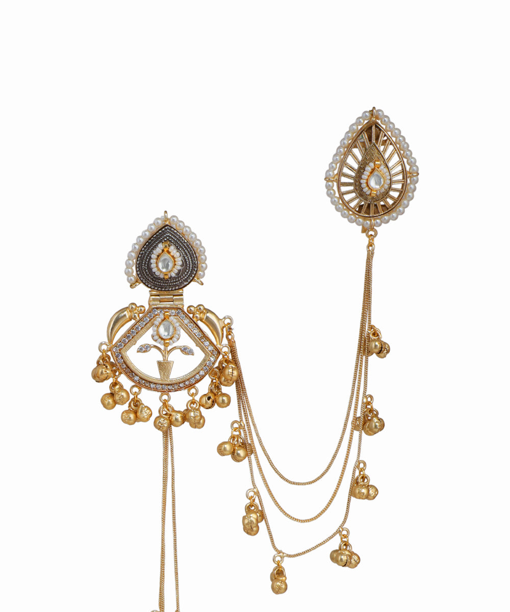 Ornate gold and silver jewelry piece on a white background