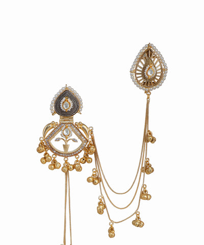 Ornate gold and silver jewelry piece on a white background