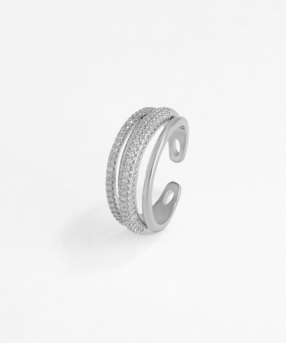 Silver open ring with embedded stones on a white background