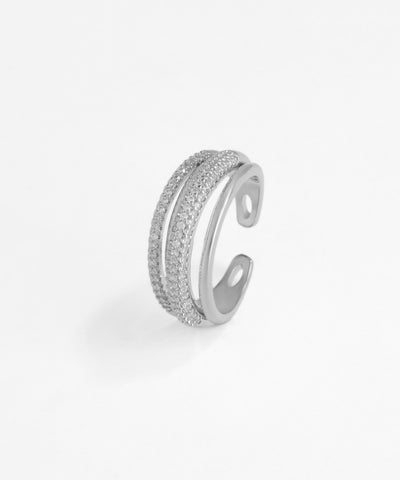 Silver open ring with embedded stones on a white background
